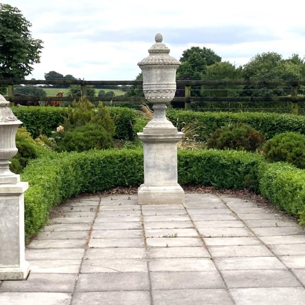 Longleat Urn flanked with Roman fluted Urn finials